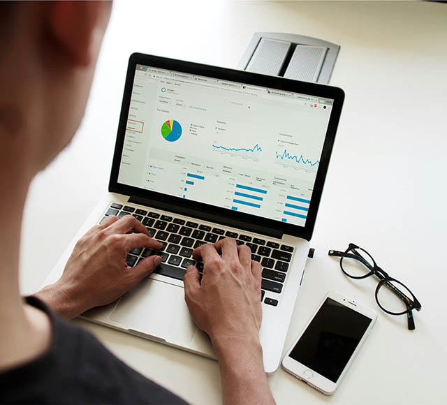 Photo of a person working on a laptop